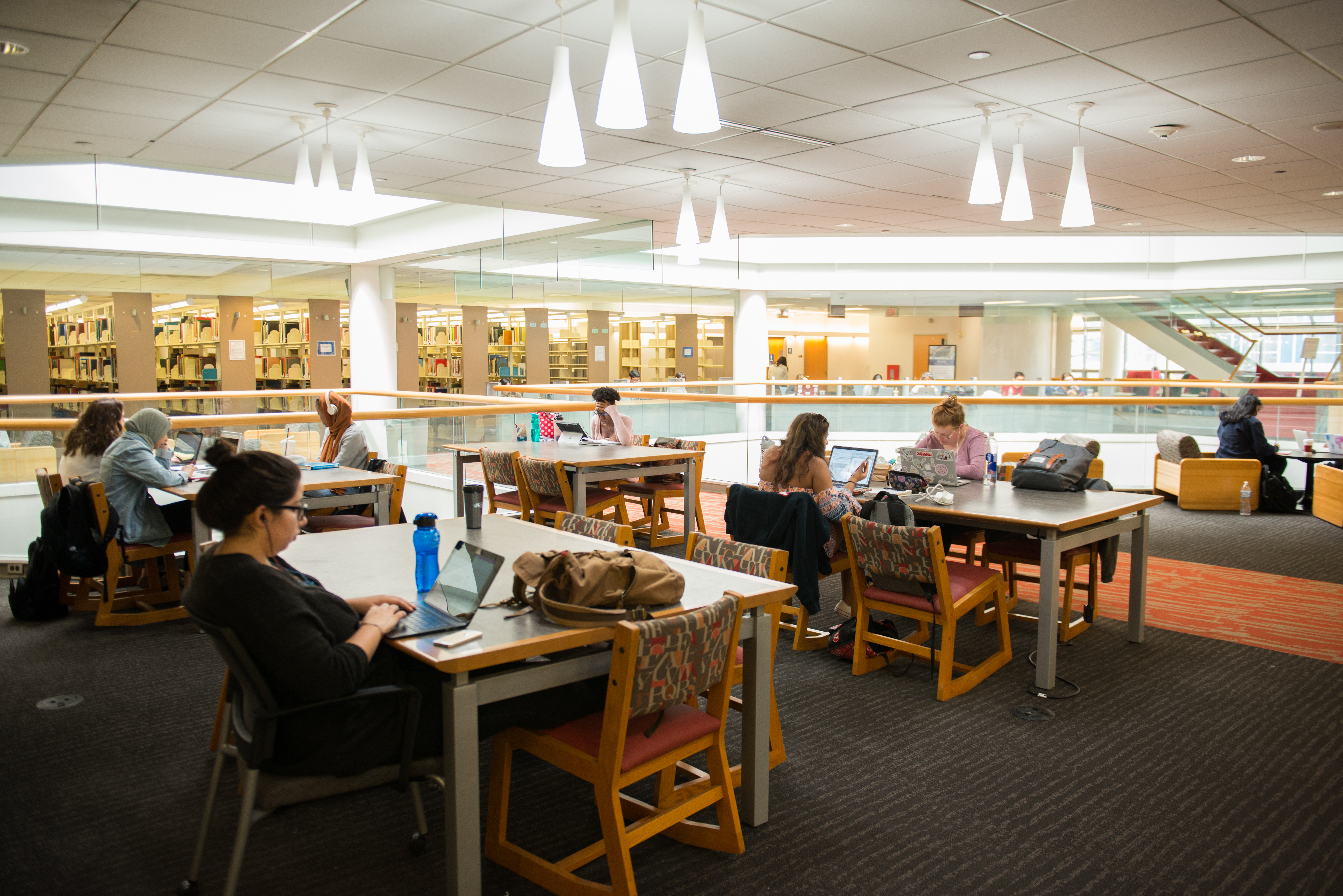 Students study at tables on the second floor of the W. W. Hagerty Library